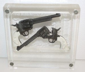 IAP two toy cap pistols encased in plastic